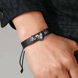 Detail of adjustable black woven leather bracelet with winged heart and Love engraving