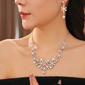 Diamond flower and pearl jewelry set with silver necklace and drop earrings on model