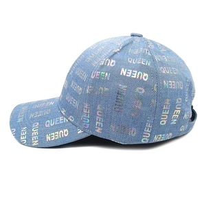 Detail of light blue denim baseball cap with colorful holographic QUEEN letter prints