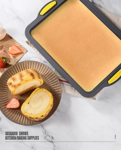 Top view of brownie baking pan with silicone handles on marble countertop with cake