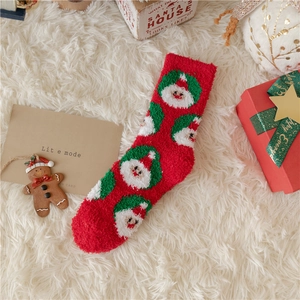 Soft coral fleece Christmas sock with Santa pattern on white plush carpet background