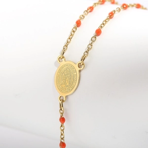 Religious necklace with gold Our Lady of Guadalupe medallion and orange beads
