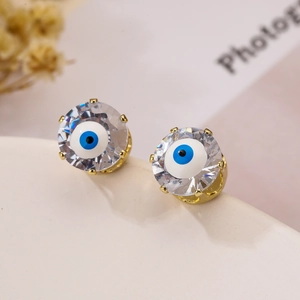 Detailed close-up of evil eye stud earrings with blue enamel and sparkling cubic zirconia