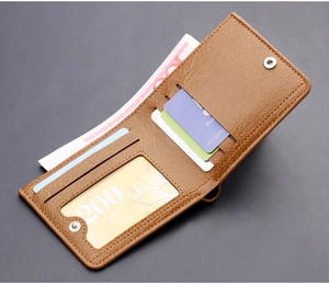 Detail of brown leather wallet interior with card slots and snap button closure