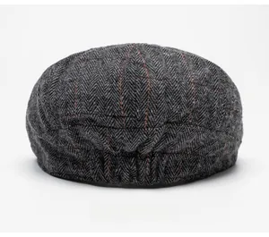 Elastic back band on wool newsboy cap with grey herringbone and red checkered pattern