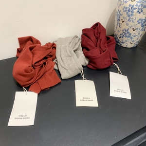 Wool blend knitted shawls in brick red, grey and wine red colors with brand tags