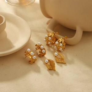 French vintage 18K gold stainless steel geometric pearl earrings on beige linen background