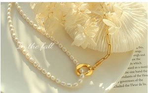 Detail of freshwater pearl necklace with 18k gold plated chain and large central link
