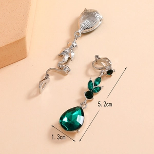 Detail view of green teardrop rhinestones silver clip-on earrings measuring 5.2cm x 1.3cm