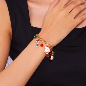 Detail shot of Christmas charm bracelet with Santa, bells and candy cane on wrist