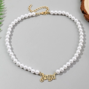 Detail of multi-layer baroque pearl necklace with golden Angel letter pendant