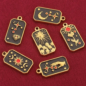 Gold stainless steel tarot card pendants with black enamel celestial and mystical symbols