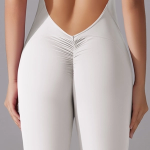 Detail of high-stretch light grey yoga jumpsuit with scrunch butt and open back design