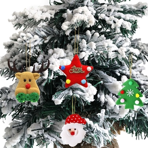 Felt Christmas ornaments with Reindeer and Santa Claus hanging on snowy pine branches