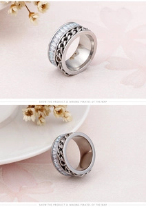 Detail of silver chain ring with baguette-cut zircon stones on a floral background