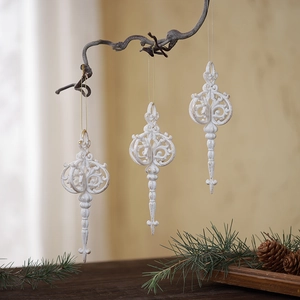 Set of 3 vintage white baroque Christmas ornaments hanging on wooden branches