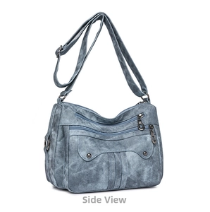 Detailed side view of blue-gray multi-layered vintage crossbody bag with metal accents