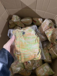 Bulk pack of green and orange knitted crocodile socks in a box showing premium texture