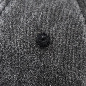 Detailed macro view of high-quality charcoal gray washed cotton baseball cap fabric