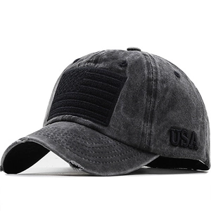 Detail of dark gray washed baseball cap with USA flag patch and vintage distressed brim