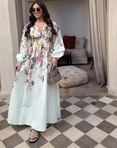 Detail of floral printed maxi dress with V-neckline and long lantern sleeves on model