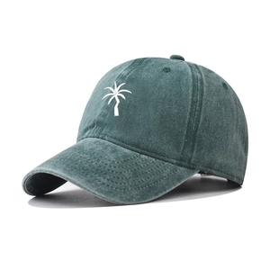 Side view of dark green washed cotton baseball cap with white palm tree embroidery