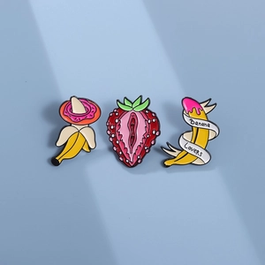 Set of 3 fruit enamel pins featuring strawberry, banana lovers, and donut on blue background