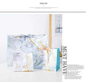Three-piece marble pattern gift bag set with satin handles in blue, gold and white