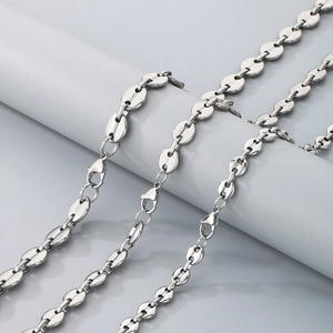 Close-up of silver coffee bean link necklace with lobster clasp and metallic finish