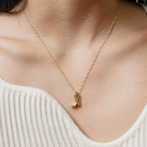 Retro gold cowboy boot pendant necklace on a delicate rope chain for women