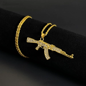 Hip hop style gold AK-47 pendant necklace with sparkling rhinestones on a twisted rope chain