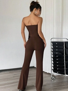 Women's chic chocolate brown two-piece set with tube top and flared trousers back view