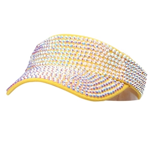 Detail of yellow sun visor hat featuring shimmering rainbow rhinestones on the brim