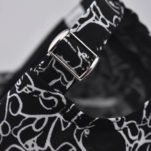 Detail of adjustable metal buckle on cartoon graffiti cotton baseball cap strap
