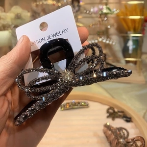 Elegant large black hair claw clip with rhinestone bow design for thick hair