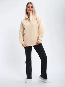 Detail showing high-quality knitted cotton texture of cream half-zip pullover sweatshirt