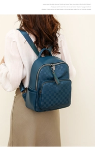 Detailed view of blue checkerboard texture and adjustable straps on women's backpack
