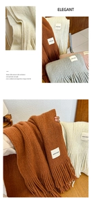 Detail of chunky knit scarf texture with handmade label in multiple cozy autumn colors