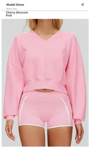 Detail of cherry blossom pink hooded sweatshirt with large front pocket and white piping