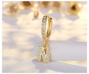 Detailed macro view of S925 silver letter N pendant earring with micro-pave zirconia