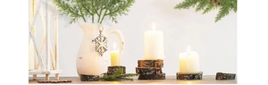 Detailed view of artificial green pine needles branches in a white ceramic vase