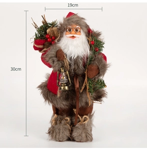 Detailed view of a 30cm standing Santa Claus figurine with a gold lantern and pine decor