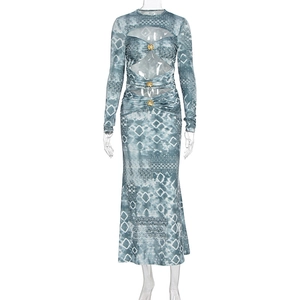 Detail view of waist cut-out on geometric print maxi dress with gold flower buttons