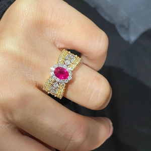 Luxurious wide band gold ring featuring a large oval ruby and pavé diamond lace design