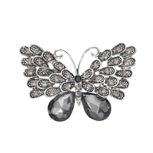 Vintage silver butterfly brooch with grey gemstones and intricate hollow metal craftsmanship