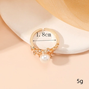 Elegant gold-plated adjustable ring with a round pearl and vine cubic zirconia accents