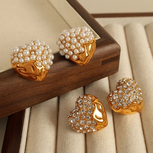 Elegant gold heart earrings set with white pearls and sparkling diamonds in a jewelry box
