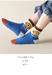 Detail of warm blue terry socks with tiger pattern and brown toe for kids