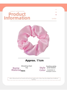 Close-up of 11cm pink LED glowing satin hair scrunchie with detailed fabric texture
