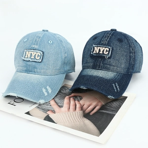 Detail of NYC 3D embroidery and distressed vintage wash on denim baseball cap